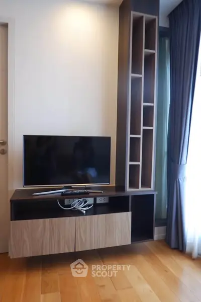 Modern living room with sleek TV stand and wooden flooring