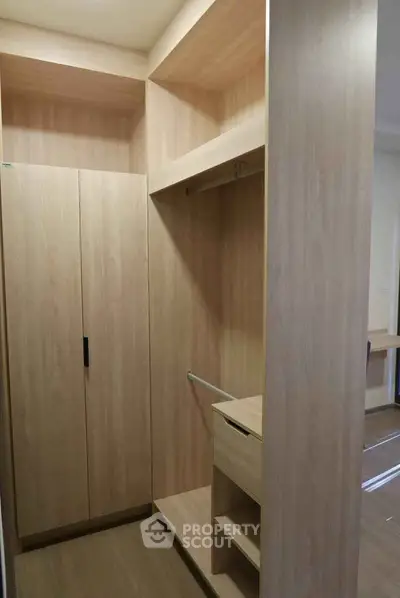 Spacious walk-in closet with wooden finish and ample storage space.