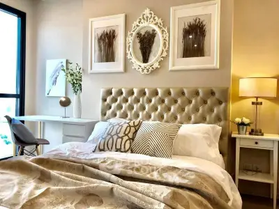 Luxurious bedroom with elegant decor and plush bedding in modern apartment.