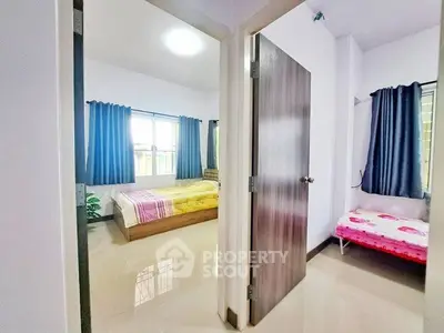 Spacious apartment with two bedrooms featuring large windows and modern decor.