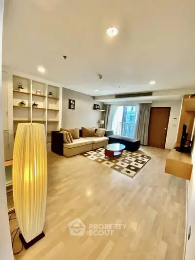 Spacious modern living room with stylish decor and large windows for natural light.