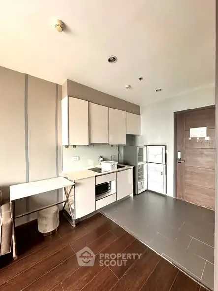 Modern kitchen with sleek cabinetry and built-in appliances in a stylish apartment.