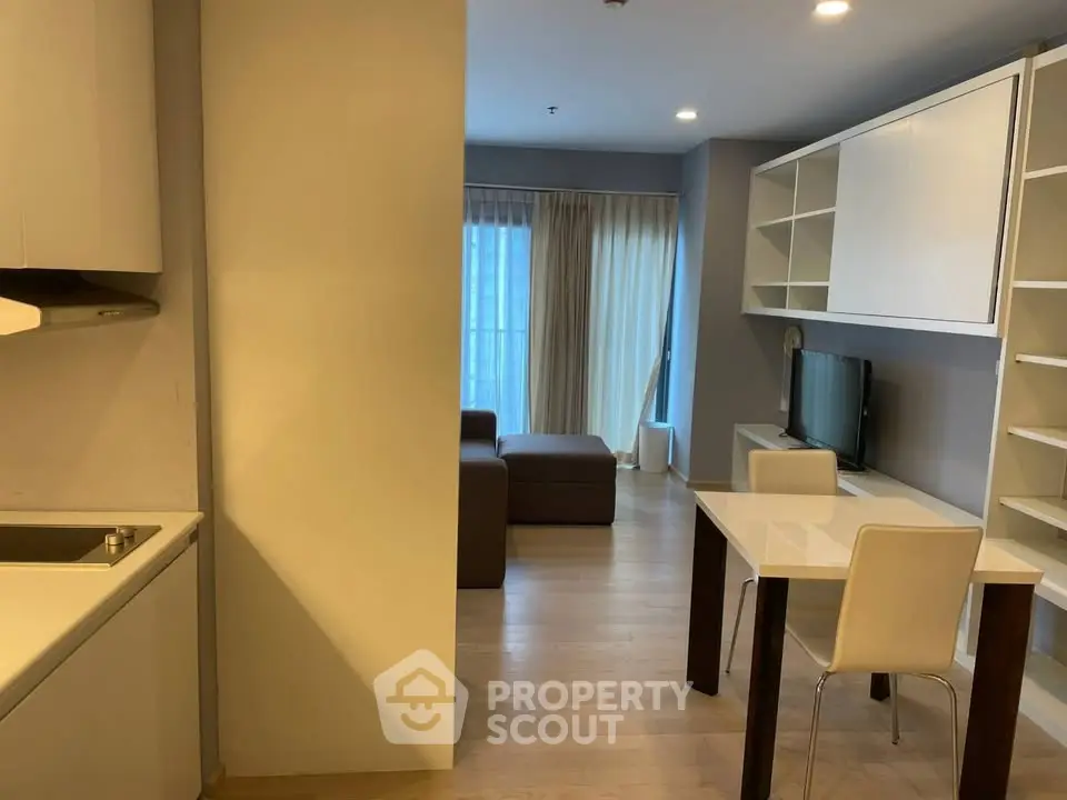 Modern open-plan living room with dining area and stylish furniture in a cozy apartment.