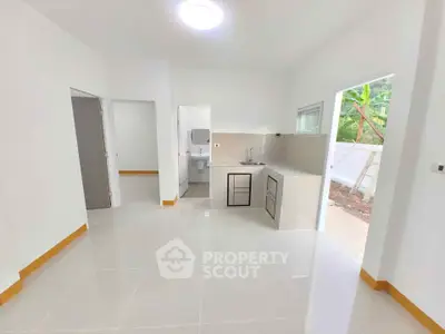 Bright and modern open-layout kitchen with sleek design and natural light.