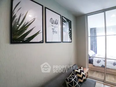 Modern living room with stylish decor and view into cozy bedroom