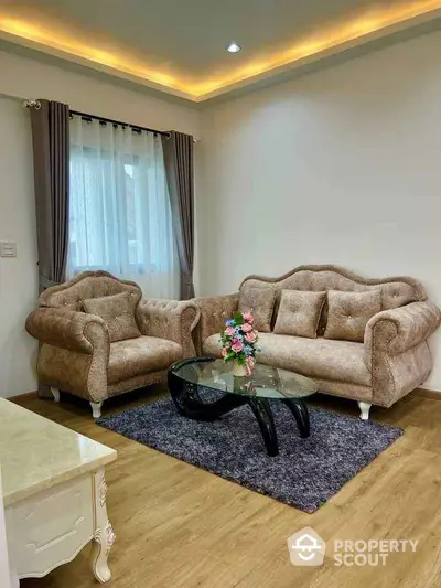 Elegant living room with plush sofas and modern glass coffee table