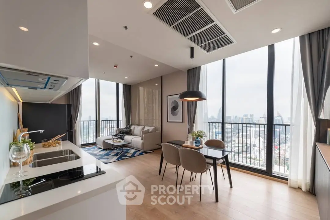 Modern open-layout living room with city view and stylish kitchen