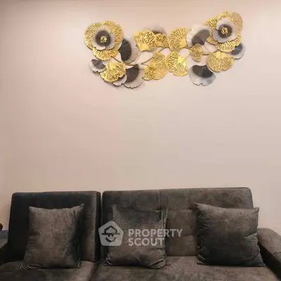 Elegant living room with stylish wall art and plush gray sofa