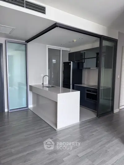 Modern kitchen with sleek design and open layout in a contemporary apartment.