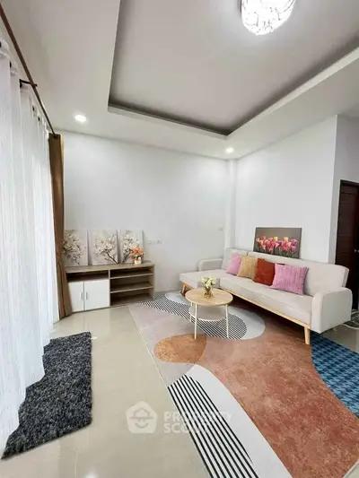 Modern living room with stylish decor and cozy seating area, perfect for relaxation and entertaining.