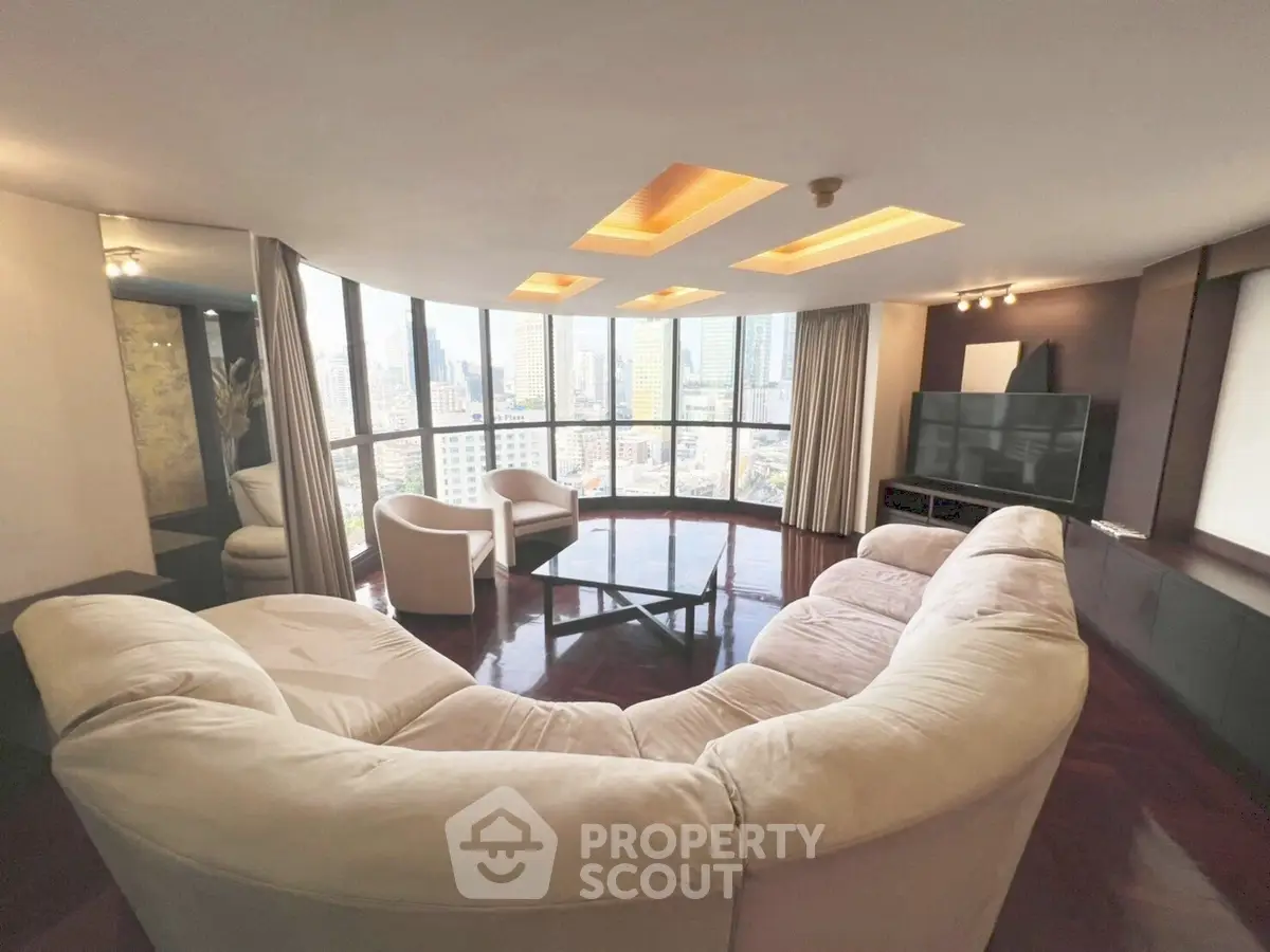 Luxurious living room with panoramic city views and plush seating