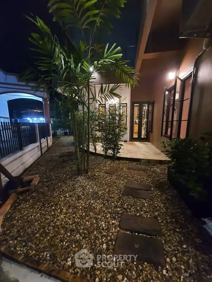 Charming night view of a cozy garden with pathway and lush greenery