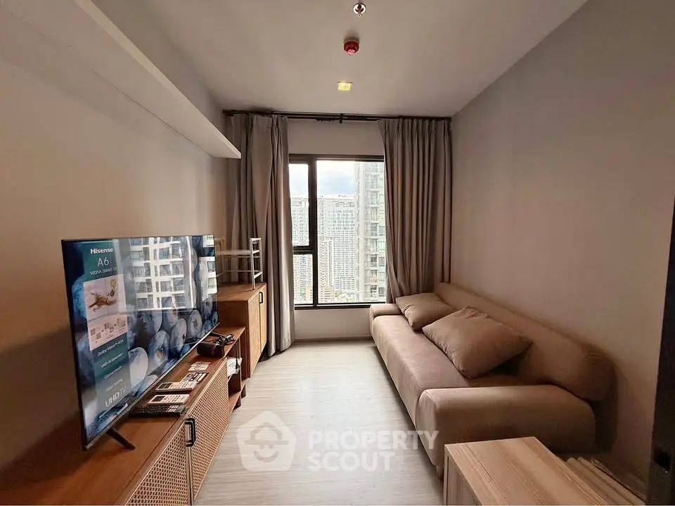 Modern living room with cozy sofa and city view window in high-rise apartment