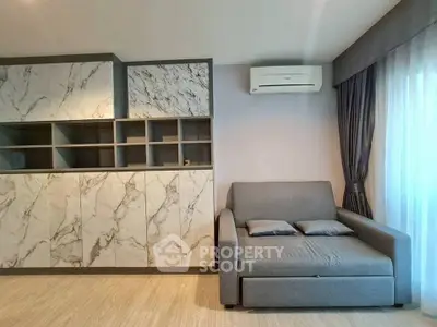 Modern living room with marble cabinetry and cozy sofa, featuring elegant curtains and air conditioning.