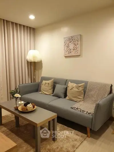 Cozy living room with stylish sofa and warm lighting, perfect for relaxation.