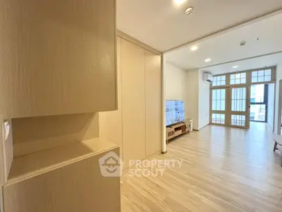 Spacious modern living room with wooden flooring and large windows