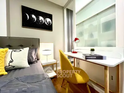 Stylish bedroom with modern decor and cozy study area, perfect for urban living.