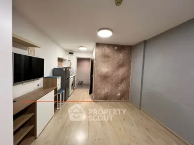 Modern living room with sleek wooden flooring and stylish wall paneling