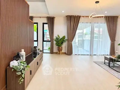 Spacious modern living room with elegant decor and large windows for natural light.