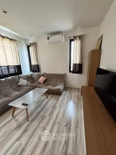 Cozy living room with modern sofa and sleek wooden flooring