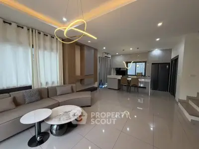 Spacious modern living room with open kitchen and stylish lighting