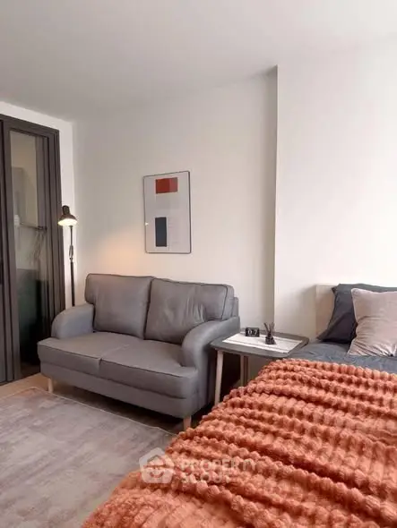 Cozy living room with modern sofa and stylish decor in a bright apartment.