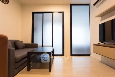 Modern living room with sleek furniture and frosted glass doors