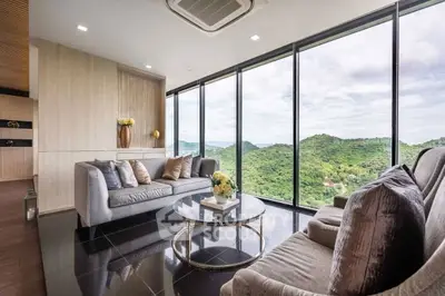 Luxurious living room with panoramic mountain views and modern decor.
