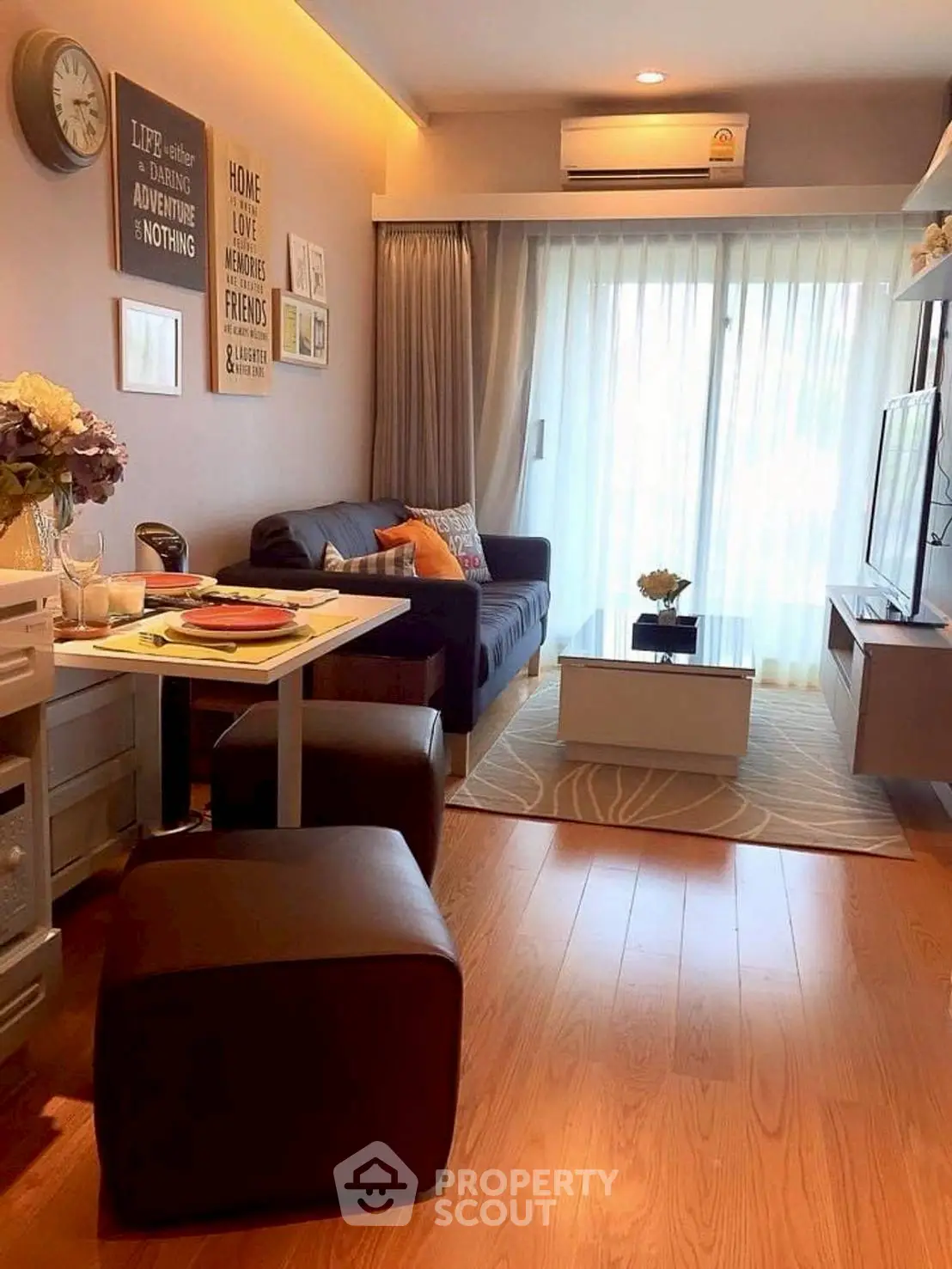 Cozy living room with modern decor and natural light, featuring a comfortable sofa and stylish furnishings.