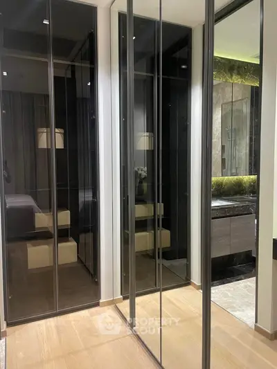 Modern bedroom with mirrored wardrobe and elegant bathroom view