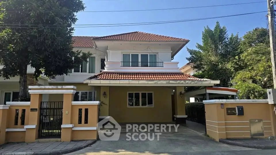 Charming two-story house with red-tiled roof and spacious driveway in a serene neighborhood.