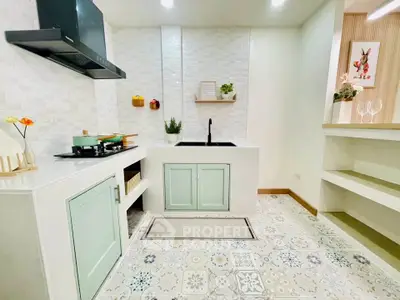 Charming kitchen with pastel cabinets and modern appliances, perfect for culinary enthusiasts.