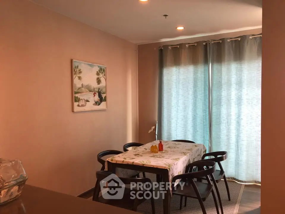 Cozy dining area with elegant table setting and natural light through curtains.