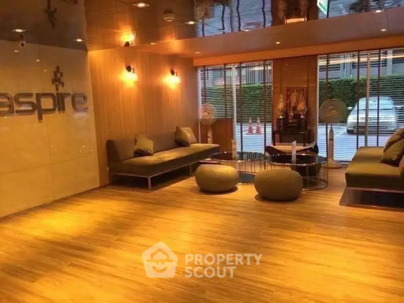 Modern lobby with stylish seating and warm lighting in a luxury residential building.