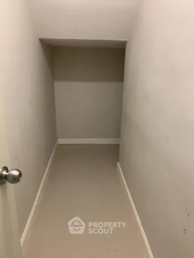 Compact storage room with neutral walls and simple flooring, ideal for organizing essentials.