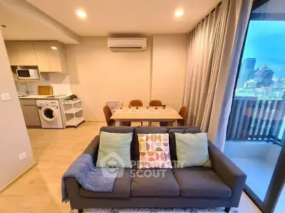 Modern living room with open kitchen and city view balcony