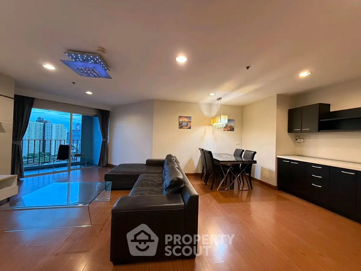 Spacious modern living room with city view and elegant furnishings.