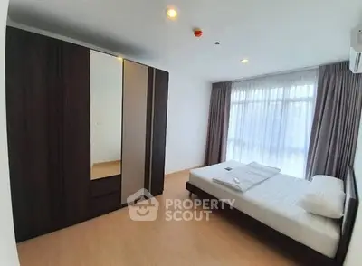 Spacious bedroom with large wardrobe and natural light