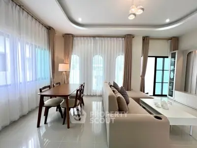 Spacious modern living room with elegant dining area and natural light
