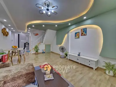 Modern living room with stylish lighting and open layout, featuring elegant decor and cozy seating area.