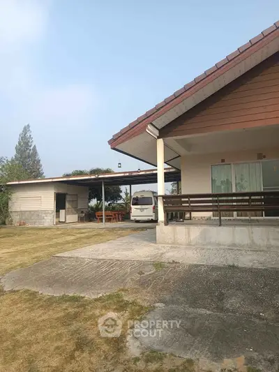 Charming suburban home with spacious yard and covered parking area