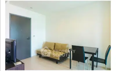 Modern living room with minimalist furniture and dining area in a bright apartment.