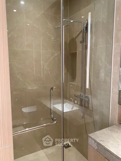 Modern bathroom with glass shower enclosure and sleek tile design
