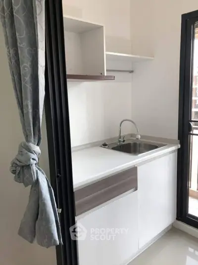 Compact modern kitchen with sleek design and natural light