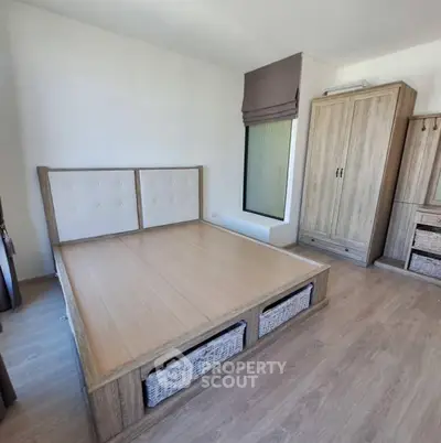 Modern minimalist bedroom with wooden furniture and natural light