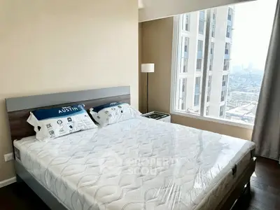 Modern bedroom with city view in high-rise apartment