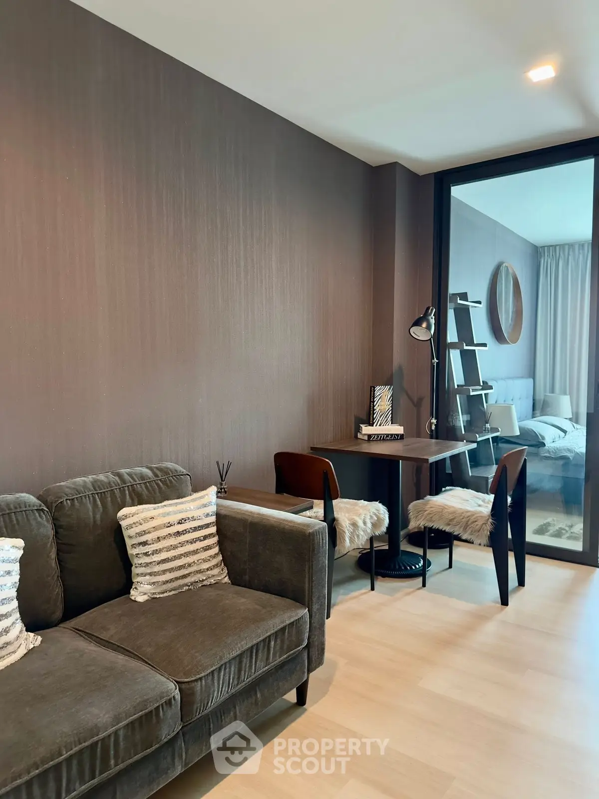 Modern living room with cozy sofa and stylish study area in a contemporary apartment.