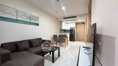 Modern living room with open kitchen, sleek furniture, and contemporary decor in a stylish apartment.