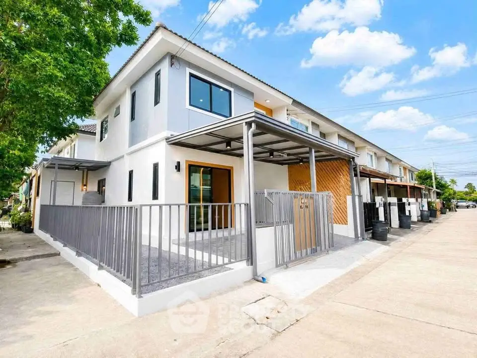 Modern two-story townhouse with sleek design and spacious outdoor area in a serene neighborhood.