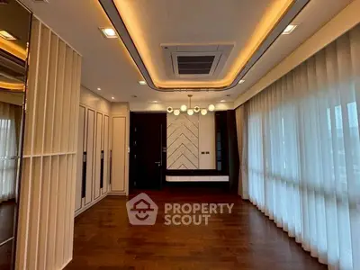 Luxurious modern living room with elegant lighting and hardwood floors